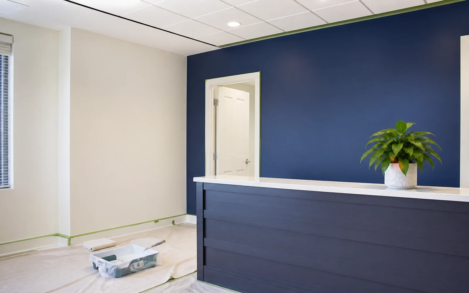 Freshly painted small office reception area with deep-indigo accent wall